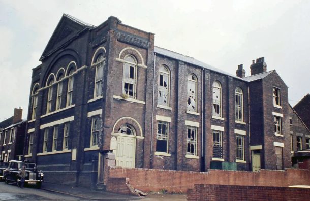 The masjid building in 1977, with broken windows before restoration