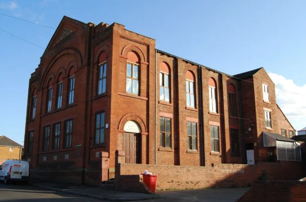 The masjid building in 2012 with its red brick exterior